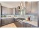 Modern kitchen with gray cabinets, gas cooktop, and white countertops at 305 W Charles St, Superior, CO 80027