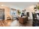 Living room featuring hardwood floors, a sofa, and armchairs at 6123 Ralston St, Frederick, CO 80530