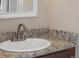 Bathroom boasts granite countertop, updated sink and faucet at 1496 S Pierson St # 116, Denver, CO 80232