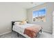 Cozy bedroom with a full-size bed and window at 12941 Delaware St, Denver, CO 80234