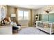 Charming Bedroom with crib, rocking chair, and large window at 17747 Prairie Peak Trl, Parker, CO 80134