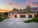 Stunning luxury home with a large driveway and landscaped yard at 6551 S Harlan Ct, Littleton, CO 80123