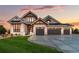 Luxury craftsman home with stone accents and a three-car garage at 6551 S Harlan Ct, Littleton, CO 80123