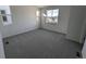 Simple bedroom with gray carpet and a large window at 8487 Eagle River St, Littleton, CO 80125
