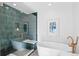 Spa-like bathroom with walk-in shower, soaking tub and green tile at 4130 Wolff St, Denver, CO 80212