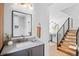 Modern bathroom with gray vanity, floating shelves and a stylish mirror at 4130 Wolff St, Denver, CO 80212