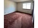 Spacious bedroom with burgundy carpet and large window at 5941 S Quail Way, Littleton, CO 80127