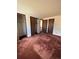 Large bedroom with double closets and burgundy carpet at 5941 S Quail Way, Littleton, CO 80127