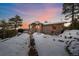 Exterior view of a cozy home during a colorful sunset in a winter setting at 8838 Hillview Rd, Morrison, CO 80465