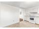 Kitchen with white cabinets and view into living room at 4170 Chase St, Denver, CO 80212