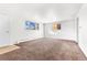 Empty living room with brown carpet and large window at 4170 Chase St, Denver, CO 80212