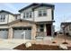 Two-story townhome with attached garage and landscaping at 6594 N Malta St, Aurora, CO 80019