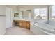Bathroom with soaking tub and double sink vanity at 9357 Lark Sparrow Dr, Highlands Ranch, CO 80126