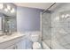 Updated bathroom with marble tile shower and a white vanity at 9357 Lark Sparrow Dr, Highlands Ranch, CO 80126