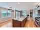 Open concept kitchen with island, hardwood floors, and access to a deck or patio at 9357 Lark Sparrow Dr, Highlands Ranch, CO 80126