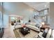 Bright and airy living room with hardwood floors, high ceilings, and an open floor plan at 9357 Lark Sparrow Dr, Highlands Ranch, CO 80126