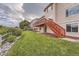 Landscaped backyard with deck and stairs at 9357 Lark Sparrow Dr, Highlands Ranch, CO 80126