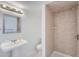 Clean bathroom with pedestal sink, shower, and toilet at 9357 Lark Sparrow Dr, Highlands Ranch, CO 80126