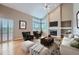 Cozy living room with hardwood floors, fireplace, and access to the kitchen at 9357 Lark Sparrow Dr, Highlands Ranch, CO 80126