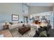 Open concept living room with hardwood floors, views of kitchen and access to outdoor space at 9357 Lark Sparrow Dr, Highlands Ranch, CO 80126