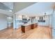 Modern kitchen with light cabinets, granite countertops, and a large island at 9357 Lark Sparrow Dr, Highlands Ranch, CO 80126