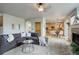 Open living room with hardwood floors, sectional sofa, and views to the kitchen at 15453 E 109Th Ave, Commerce City, CO 80022