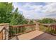 Private deck overlooking neighborhood with stone pillars and wood railing at 15453 E 109Th Ave, Commerce City, CO 80022