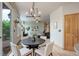 Casual dining area with dark wood table and chairs, looking toward living room at 15453 E 109Th Ave, Commerce City, CO 80022