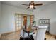 Bright home office with hardwood floors, built-in shelving, and French doors at 15453 E 109Th Ave, Commerce City, CO 80022
