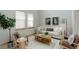Living room features a light-colored sofa, two armchairs, and a coffee table at 15453 E 109Th Ave, Commerce City, CO 80022