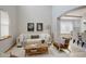 Spacious living room with hardwood floors, neutral decor, and a view into the dining area at 15453 E 109Th Ave, Commerce City, CO 80022