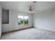 Simple bedroom with carpeted floors and a large window at 15453 E 109Th Ave, Commerce City, CO 80022