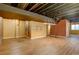 Open basement area with laminate flooring and exposed beams at 15453 E 109Th Ave, Commerce City, CO 80022