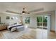 Spacious main bedroom with wood floors, fireplace, and private deck access at 15453 E 109Th Ave, Commerce City, CO 80022