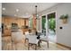 Eat-in kitchen with island, hardwood floors, and access to the backyard patio at 15453 E 109Th Ave, Commerce City, CO 80022