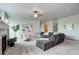 Finished basement with sectional sofa, fireplace, and large windows at 15453 E 109Th Ave, Commerce City, CO 80022