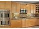 Kitchen with stainless steel appliances, light wood cabinets, and granite countertops at 15453 E 109Th Ave, Commerce City, CO 80022