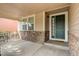 Covered front porch with stone accents and a dark green door at 15453 E 109Th Ave, Commerce City, CO 80022