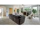Spacious living room with a cozy sectional sofa and fireplace at 15453 E 109Th Ave, Commerce City, CO 80022