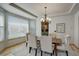 Bright dining room featuring a wooden table and six chairs, with kitchen access at 15453 E 109Th Ave, Commerce City, CO 80022