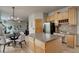 Kitchen boasts light wood cabinets, a large island, and stainless steel appliances at 15453 E 109Th Ave, Commerce City, CO 80022