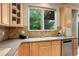 Bright kitchen with light wood cabinets, stainless steel appliances, and granite countertops at 15453 E 109Th Ave, Commerce City, CO 80022