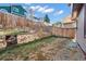 Landscaped backyard with stone retaining wall and fire pit at 9432 W 104Th Way, Broomfield, CO 80021