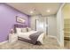 Basement bedroom with purple walls and access to a large common area at 2349 Leafdale Cir, Castle Rock, CO 80109