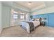 Spacious main bedroom with carpeted floors, large windows, and blue accent wall at 2349 Leafdale Cir, Castle Rock, CO 80109