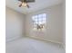 Cozy bedroom with large window and neutral-toned carpet at 17040 Campo Dr, Parker, CO 80134