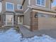 Welcoming front entryway with brick accents and a concrete walkway at 17040 Campo Dr, Parker, CO 80134