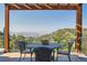 Relaxing covered deck with scenic mountain views and outdoor seating at 486 Andromeda Ln, Castle Rock, CO 80108