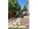 Landscaped backyard with stone pathway and mature trees at 2393 Fairway Wood Cir, Castle Rock, CO 80109