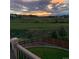 Sunset view from deck overlooking golf course and community at 2393 Fairway Wood Cir, Castle Rock, CO 80109